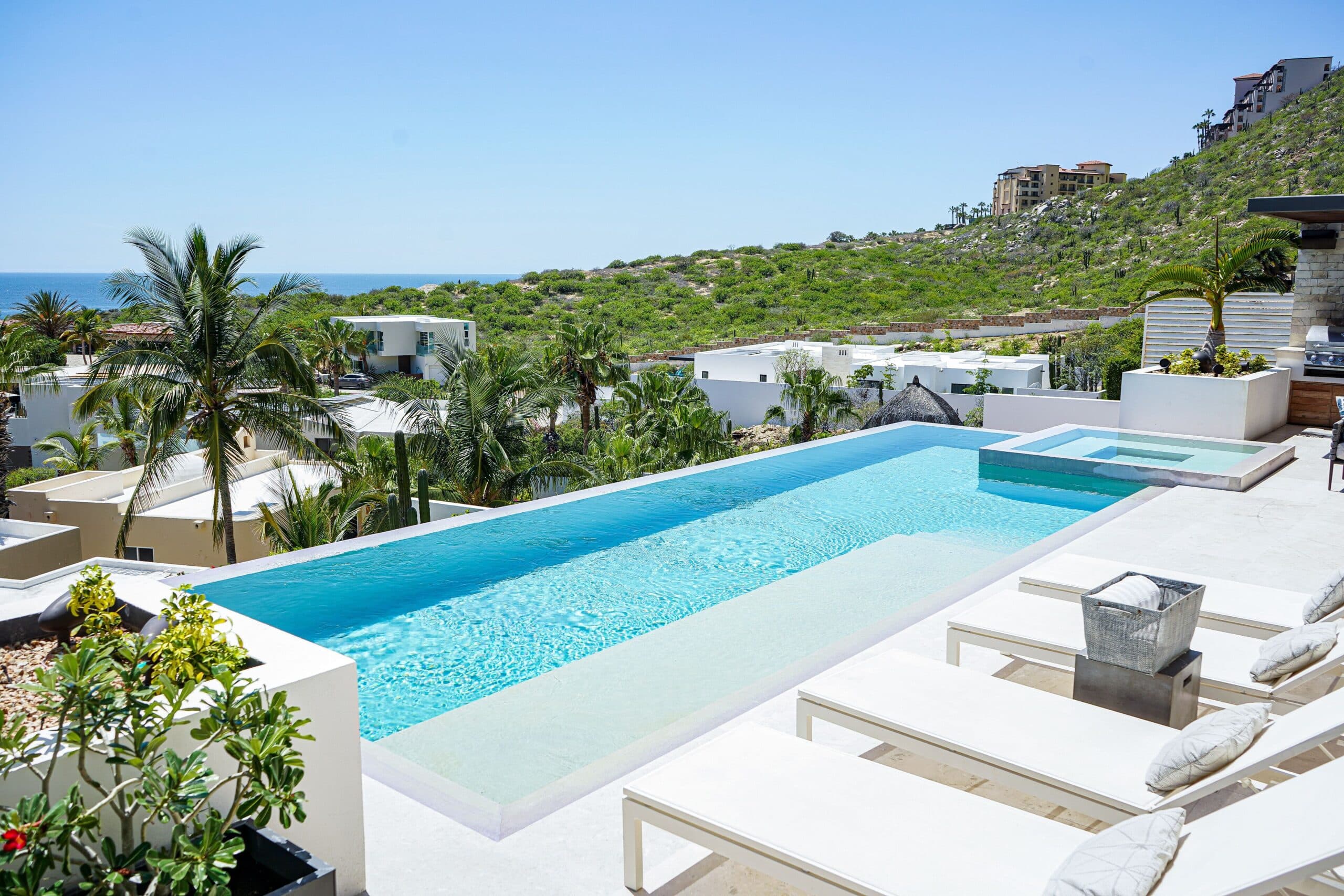 Casa Texas infinity pool and terrace in Pedregal, Cabo San Lucas, looking toward the hillside and Pacific